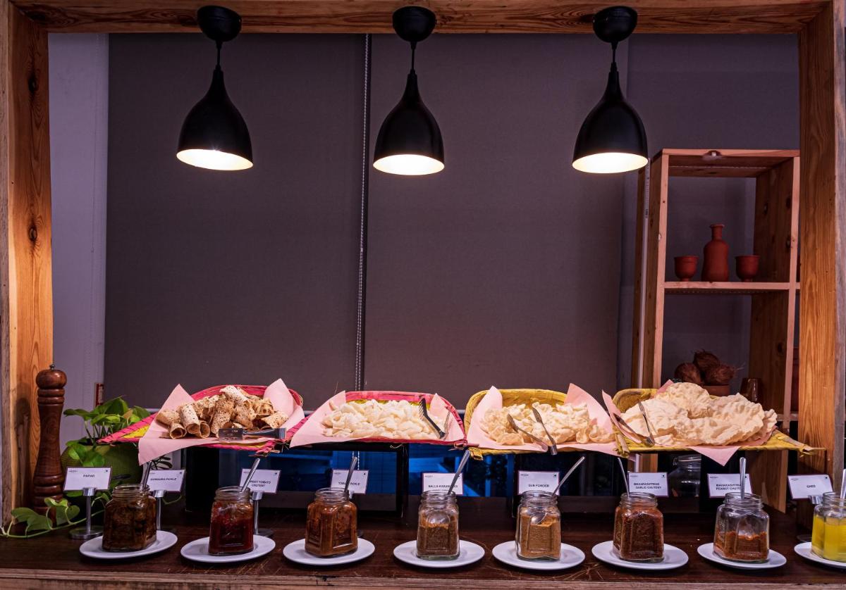 a table with many different types of food on plates at Mercure Hyderabad KCP Banjara Hills, An Accor Hotel in Hyderabad