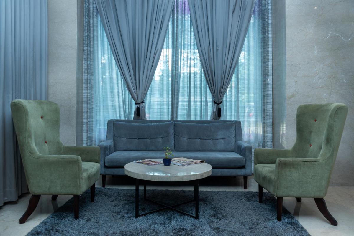 a living room with a couch and two chairs and a table at Mercure Hyderabad KCP Banjara Hills, An Accor Hotel in Hyderabad