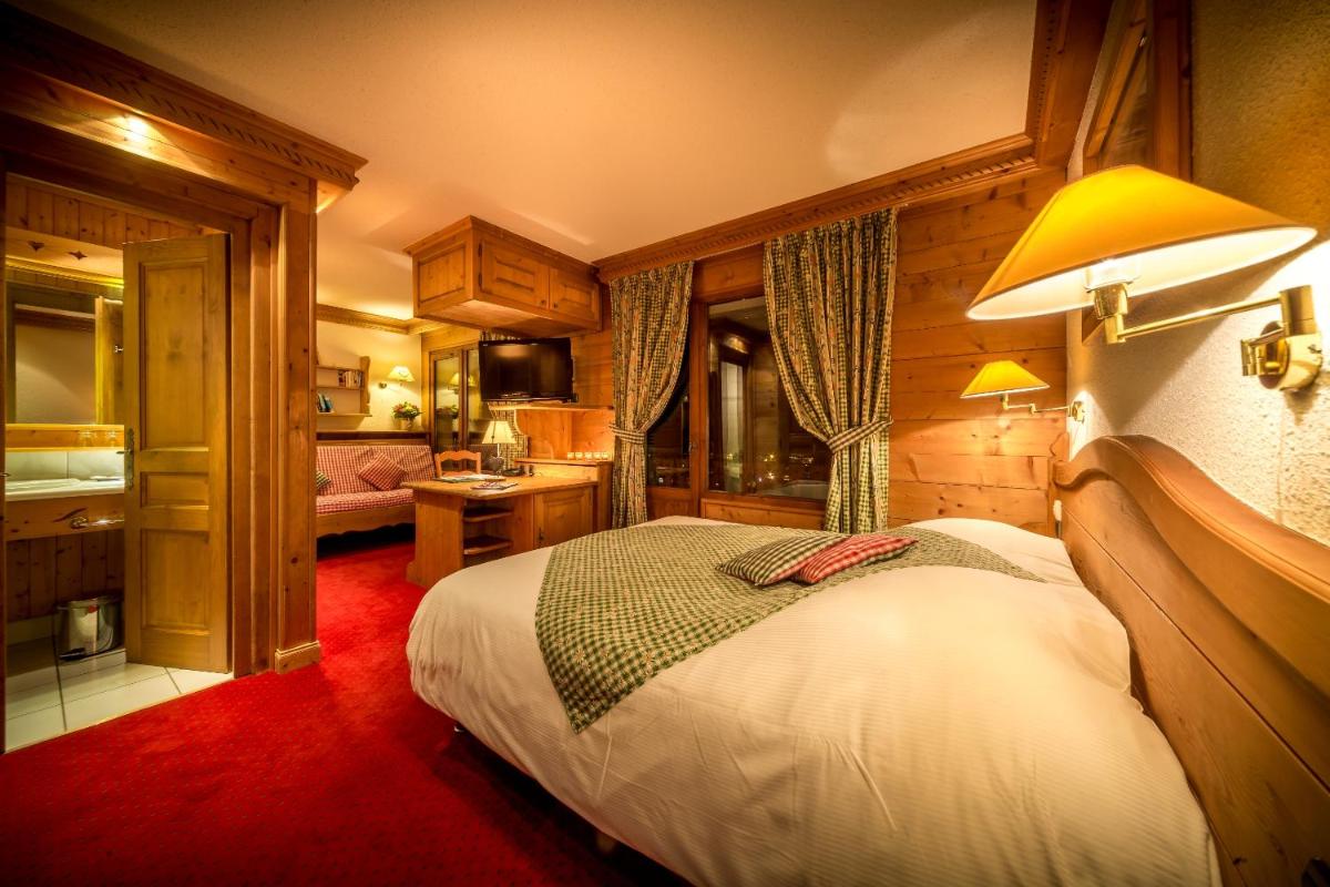 Un ou plusieurs lits dans un hébergement de l'établissement Hotel & Spa Le Dahu