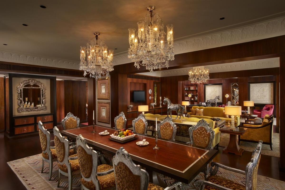 a dining room with a table and chairs at The Leela Palace Udaipur in Udaipur