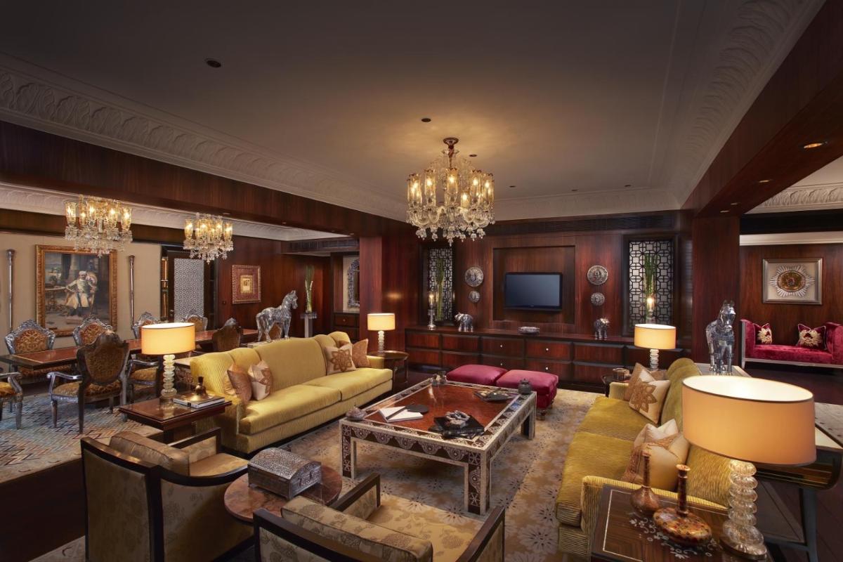 a living room with a couch and a table at The Leela Palace Udaipur in Udaipur