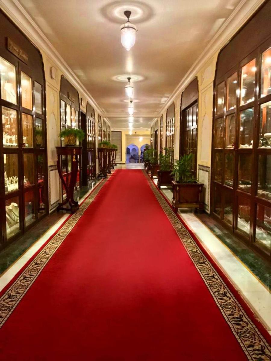 a red carpet in a hallway with a red floor at The Raj Palace (Small Luxury Hotels of the World) in Jaipur