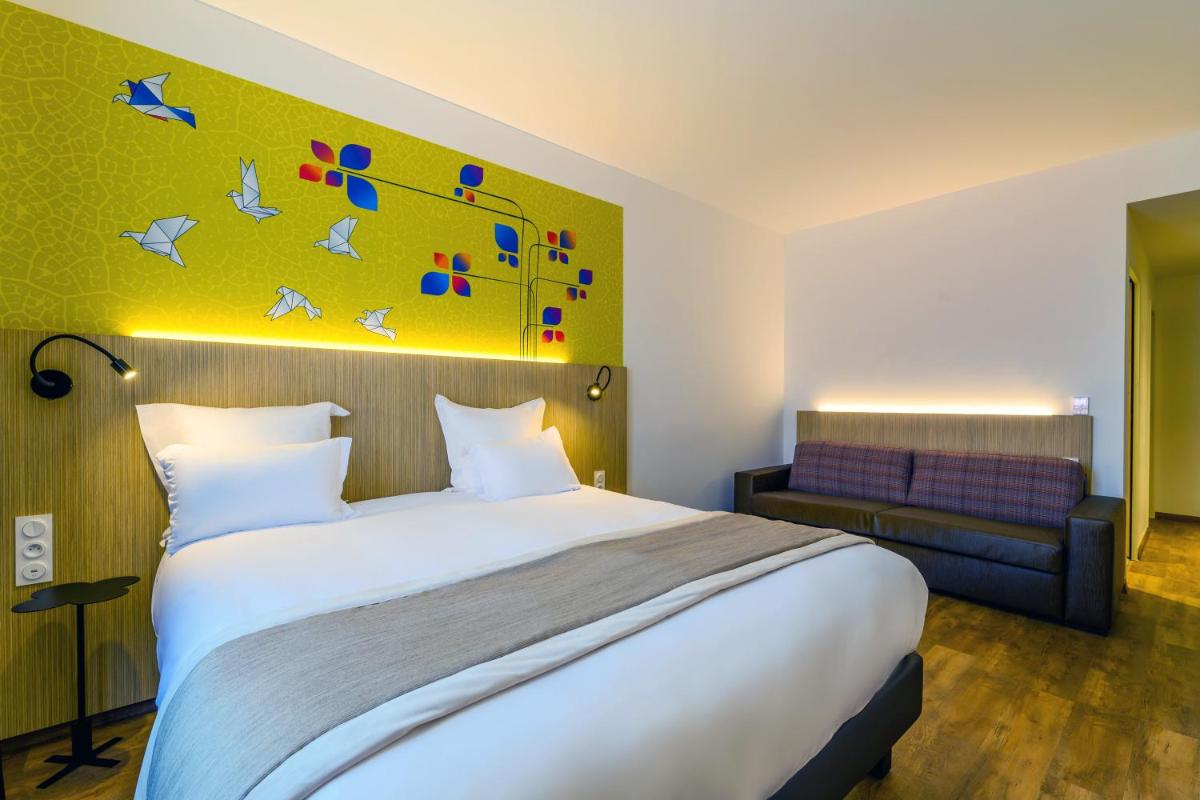 Un ou plusieurs lits dans un hébergement de l'établissement Kyriad Prestige Amiens Poulainville - Hotel and Spa