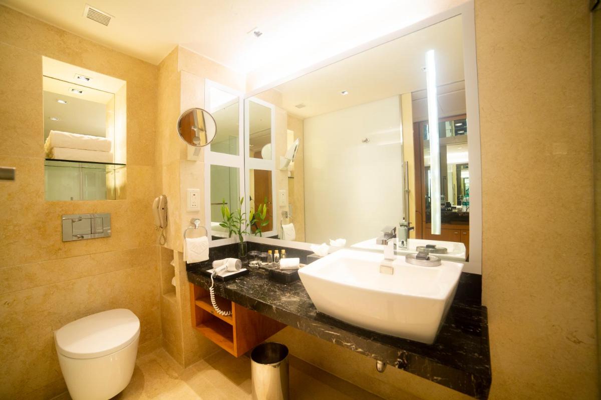 a bathroom with a sink and a toilet at Taj Club House in Chennai