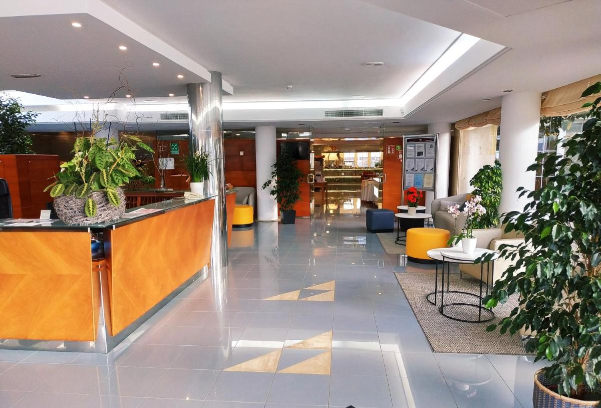 un vestíbulo con recepción y macetas en Hotel Capricho, en Cala Ratjada 90 fotos más