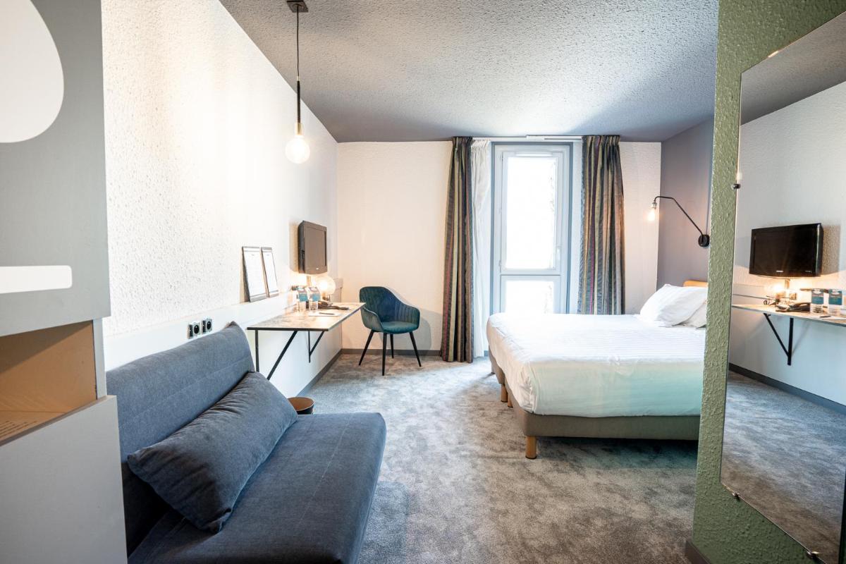 Un ou plusieurs lits dans un hébergement de l'établissement PoMo Hôtel & Restaurant