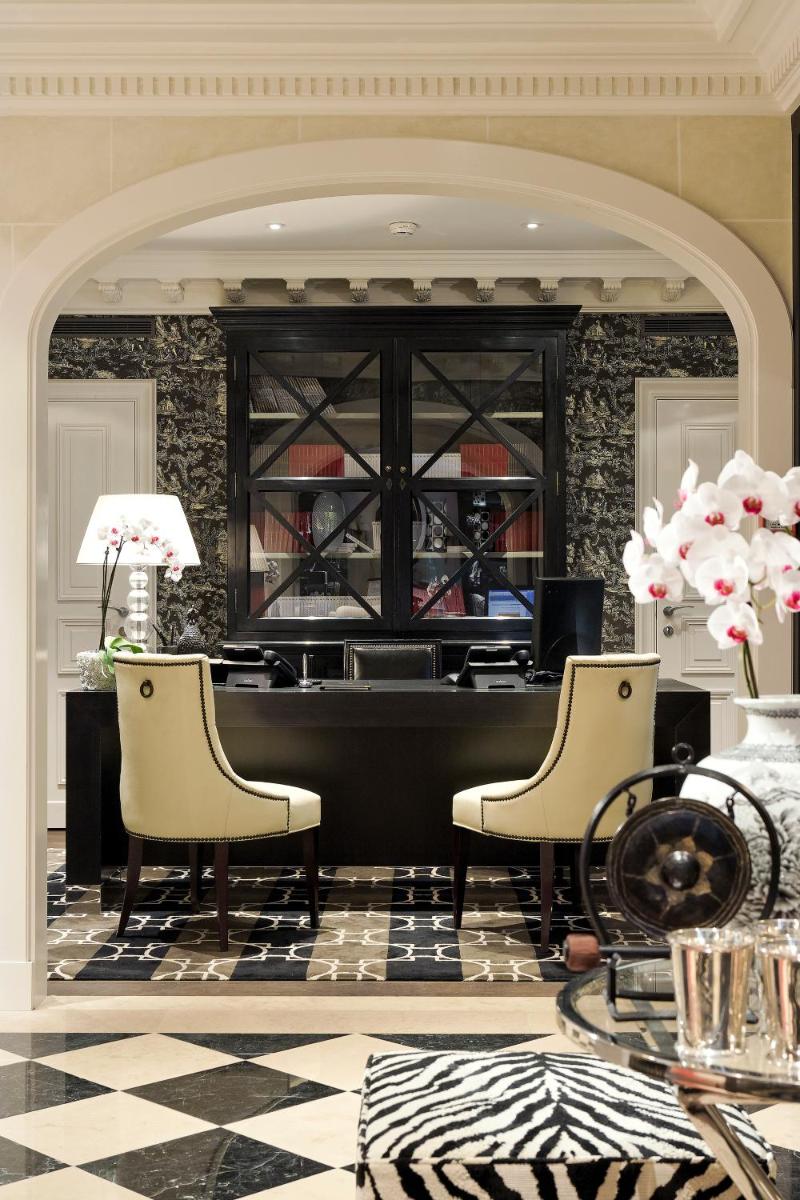 - un hall avec un bureau, deux chaises et une table dans l'établissement Hôtel Keppler, à Paris
