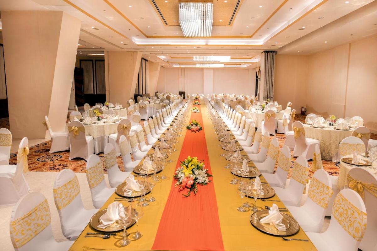 a long banquet hall with white tables and white chairs at Welcomhotel by ITC Hotels, Dwarka, New Delhi in New Delhi a long banquet hall with white tables and white chairs at Welcomhotel by ITC Hotels, Dwarka, New Delhi in New Delhi