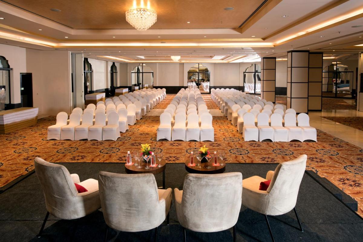 a banquet hall with white chairs and tables in a room at Welcomhotel by ITC Hotels, Dwarka, New Delhi in New Delhi a banquet hall with white chairs and tables in a room at Welcomhotel by ITC Hotels, Dwarka, New Delhi in New Delhi