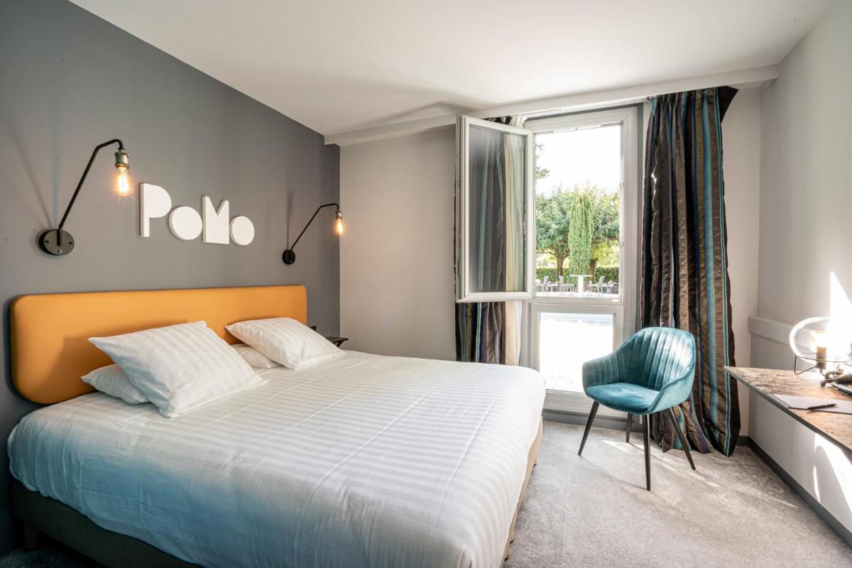 Un ou plusieurs lits dans un hébergement de l'établissement PoMo Hôtel & Restaurant