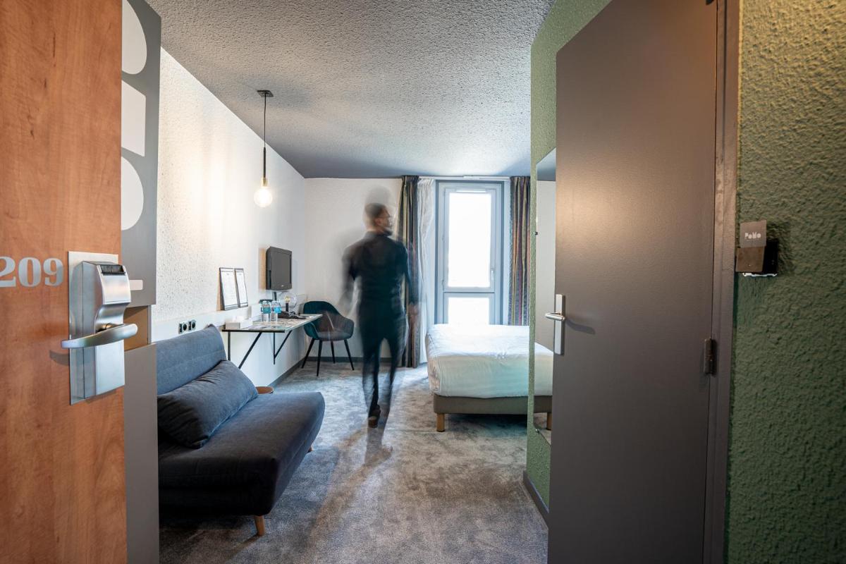 Un ou plusieurs lits dans un hébergement de l'établissement PoMo Hôtel & Restaurant