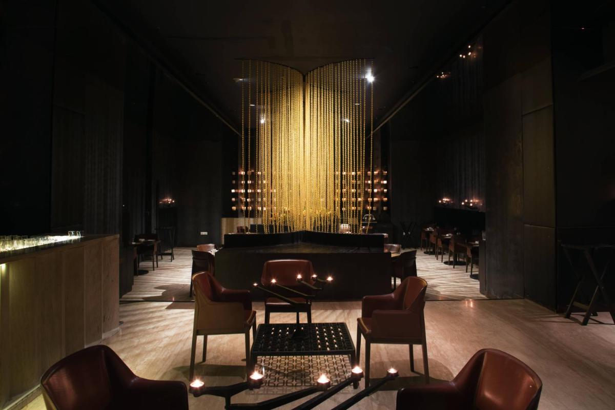 a piano in a room with chairs and lights at Welcomhotel by ITC Hotels, Dwarka, New Delhi in New Delhi a piano in a room with chairs and lights at Welcomhotel by ITC Hotels, Dwarka, New Delhi in New Delhi