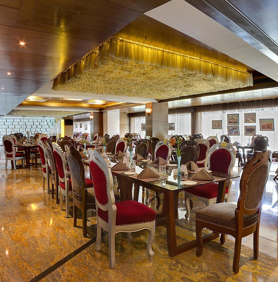 a dining room filled with tables and chairs at La Marvella, Bengaluru in Bengaluru