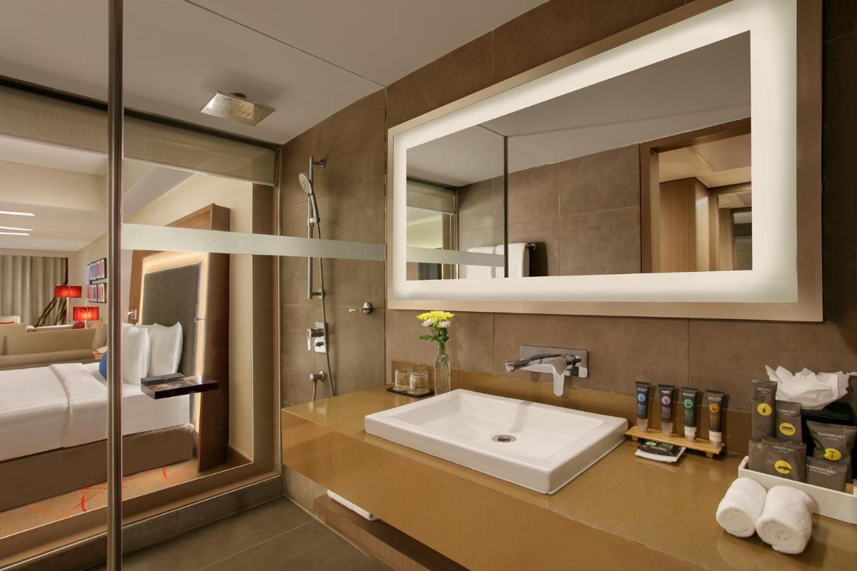 a bathroom with a sink and a mirror at Novotel Ahmedabad in Ahmedabad