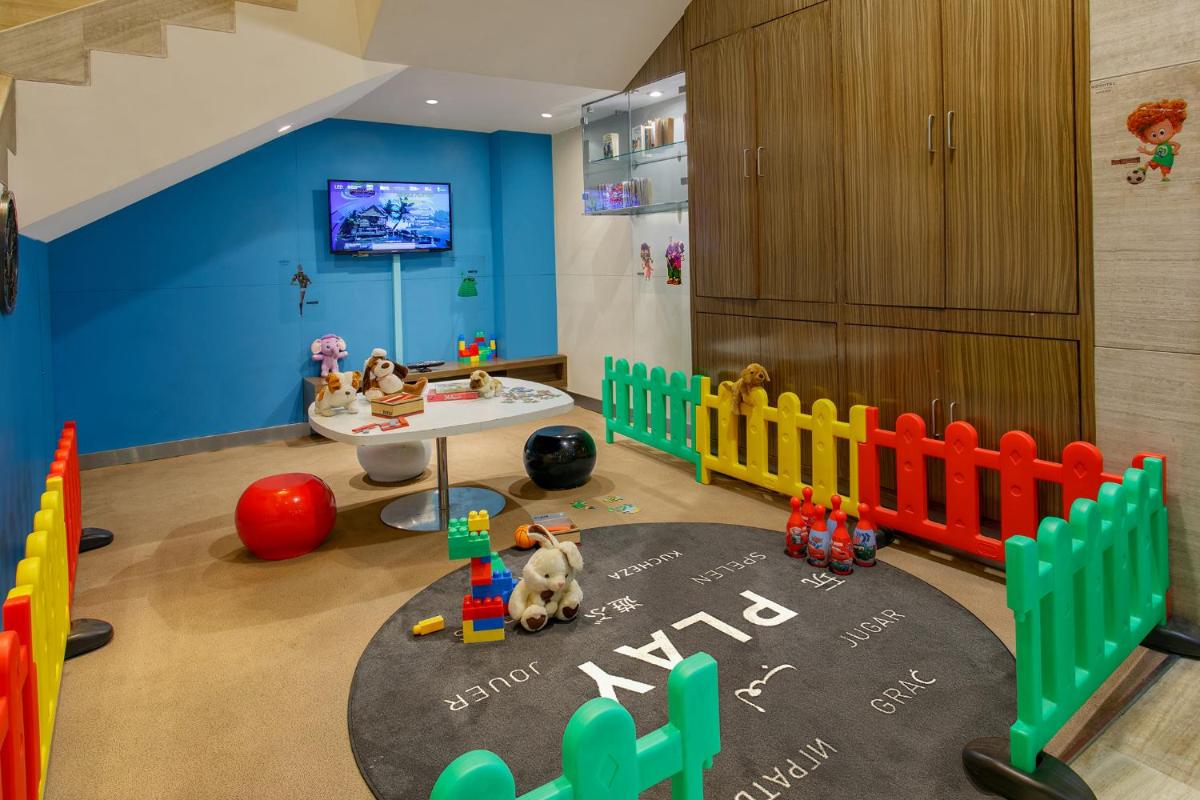 a childs room with a table and toys in it at Novotel Ahmedabad in Ahmedabad