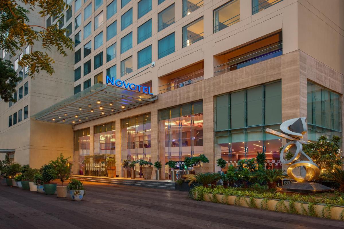 a building with a sign on the front of it at Novotel Ahmedabad in Ahmedabad