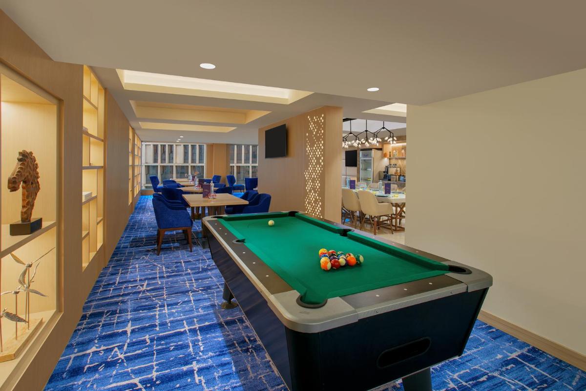 a billiard room with a pool table in it at Novotel Ahmedabad in Ahmedabad