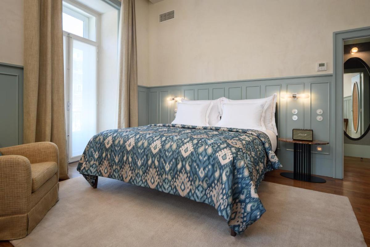 Uma cama ou camas num quarto em Bairro Alto Hotel