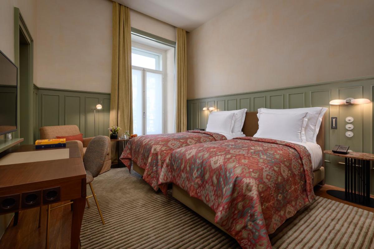 Uma cama ou camas num quarto em Bairro Alto Hotel