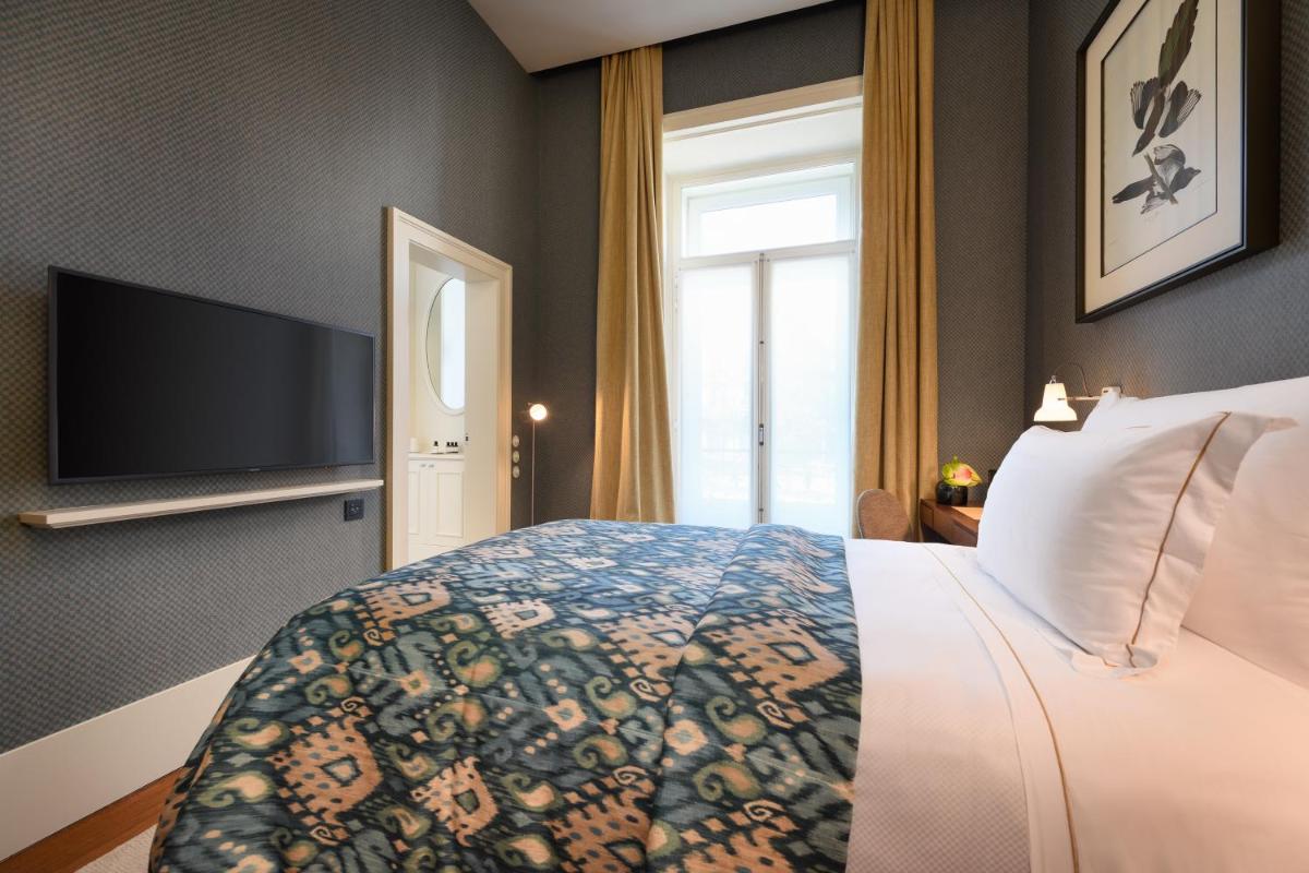 Uma cama ou camas num quarto em Bairro Alto Hotel