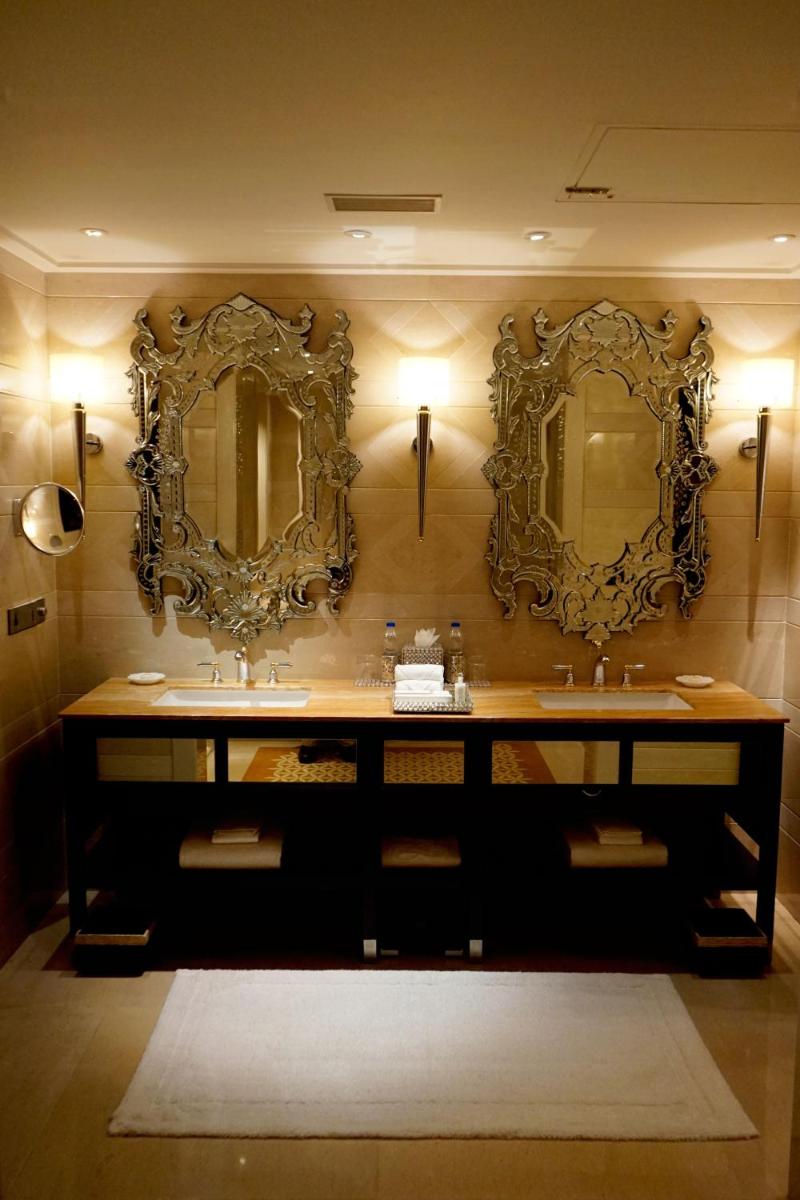 a bathroom with two sinks and mirrors on the wall at The Leela Palace Udaipur in Udaipur