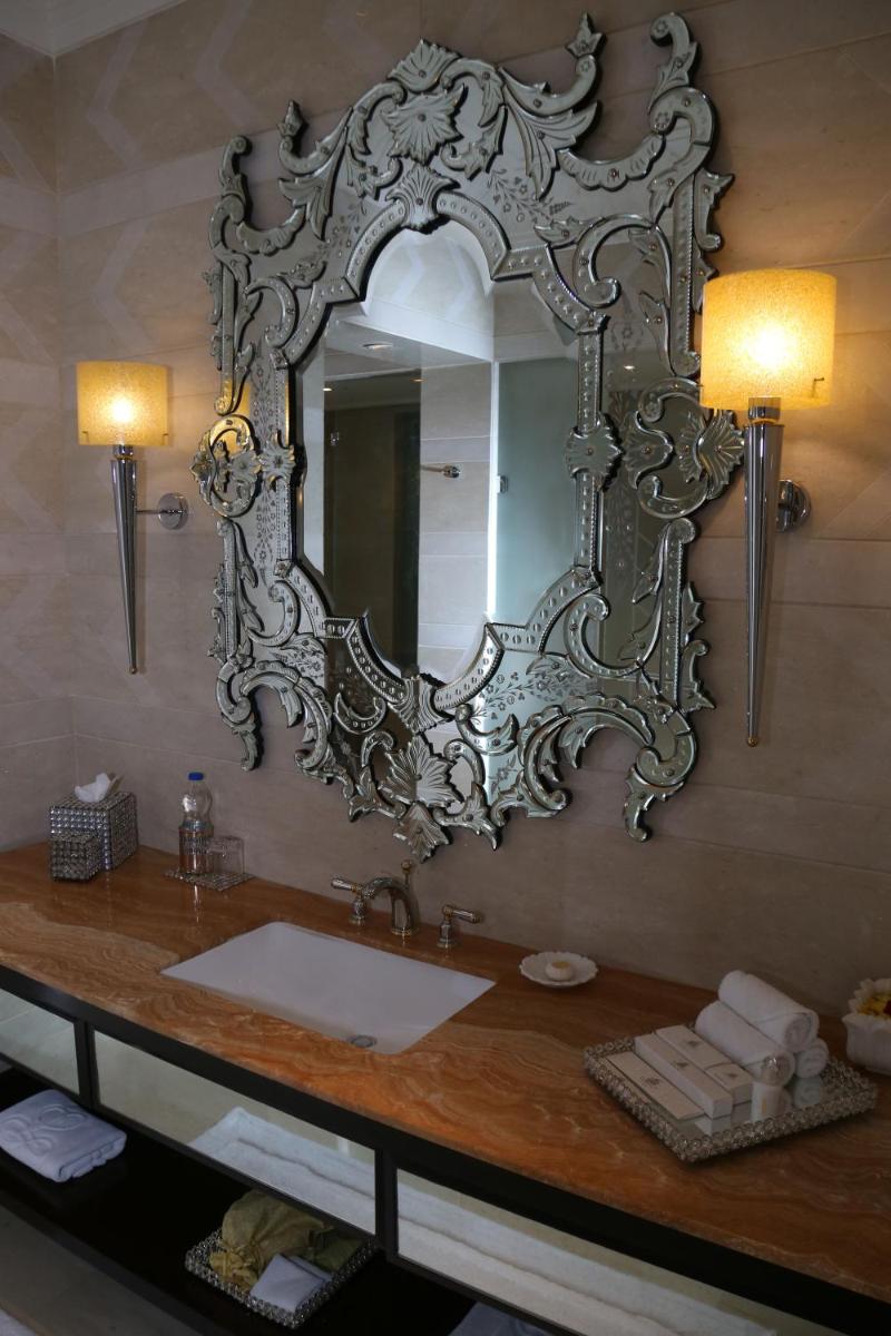 a bathroom with a sink and a mirror on the wall at The Leela Palace Udaipur in Udaipur