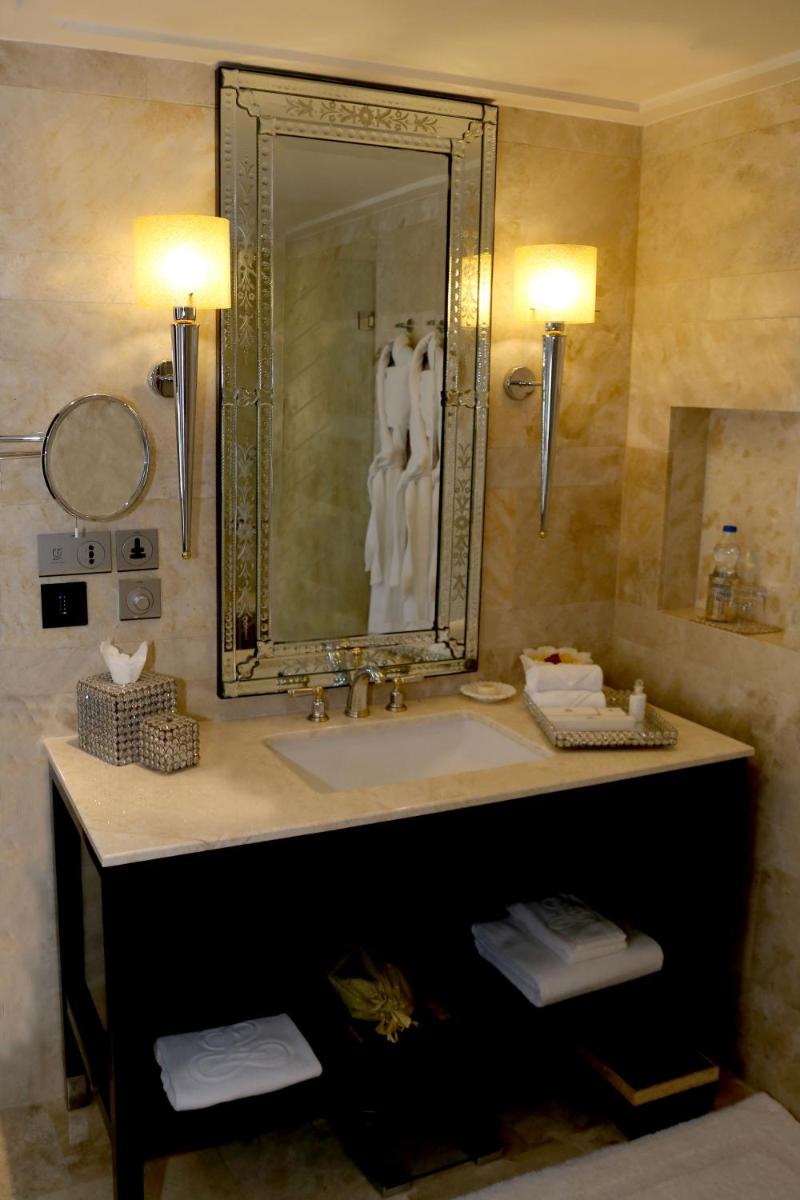 a bathroom with a sink and a mirror at The Leela Palace Udaipur in Udaipur