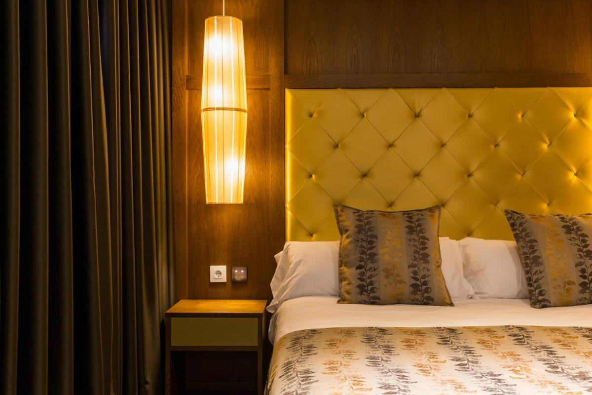 Cama o camas de una habitación en Sant Jordi Boutique Hotel