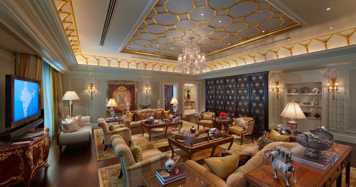 a living room filled with furniture and a chandelier at The Leela Palace New Delhi in New Delhi a living room filled with furniture and a chandelier at The Leela Palace New Delhi in New Delhi