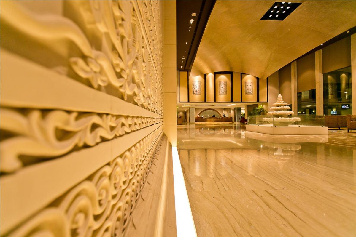 a view of the lobby of a building with a wall at The Lalit Jaipur in Jaipur
