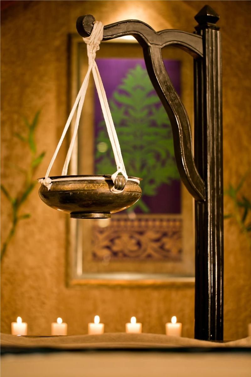 a wooden scale with candles in a room at The Lalit Jaipur in Jaipur