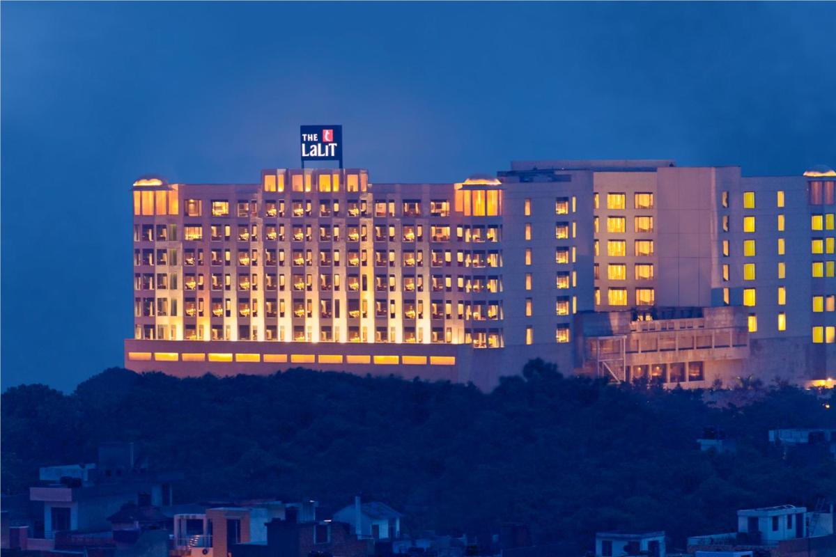 a lit up hotel with a sign on top of it at The Lalit Jaipur in Jaipur