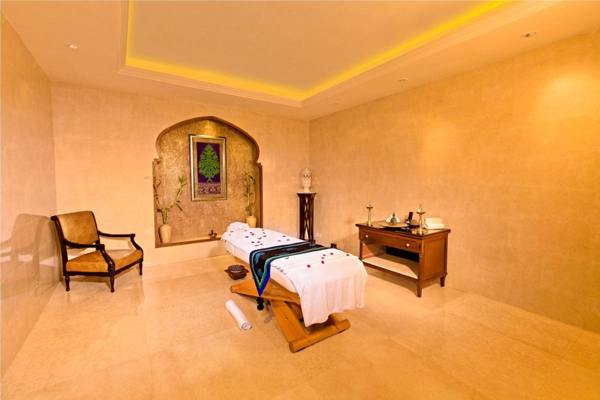 a hospital room with a bed and a desk at The Lalit Jaipur in Jaipur