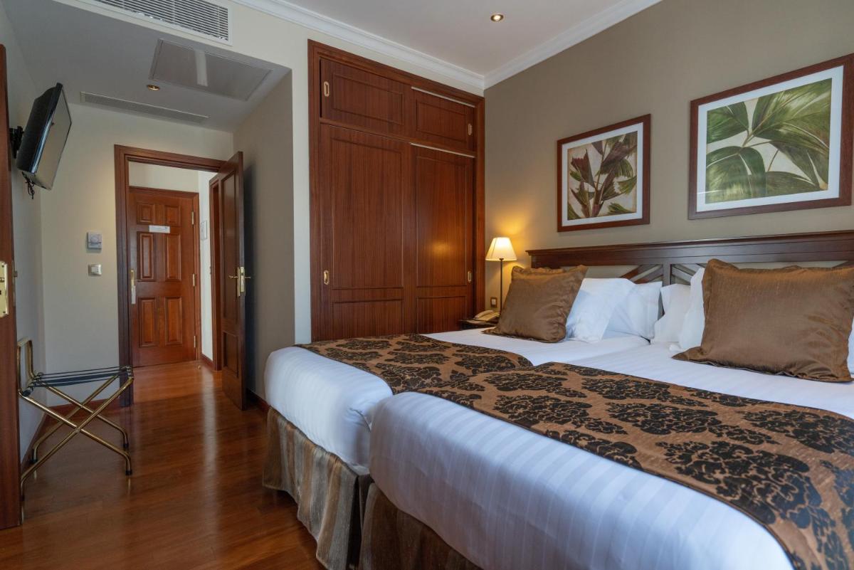 Cama o camas de una habitación en Laguna Nivaria Hotel & Spa