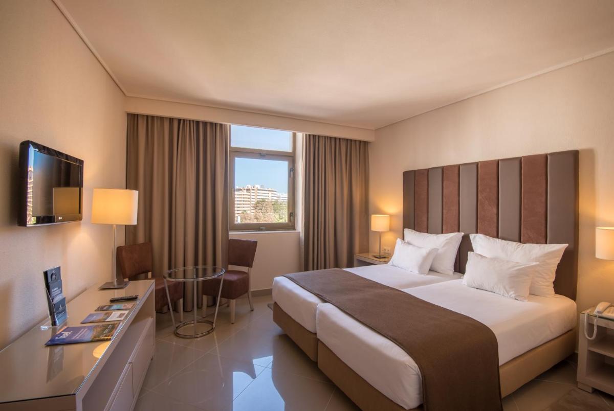 Uma cama ou camas num quarto em Vila Gale Ampalius