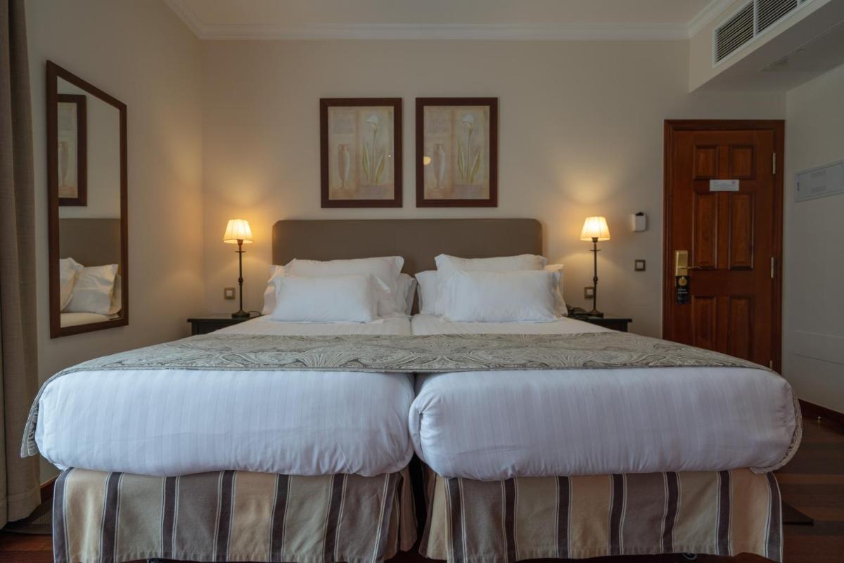 Cama o camas de una habitación en Laguna Nivaria Hotel & Spa