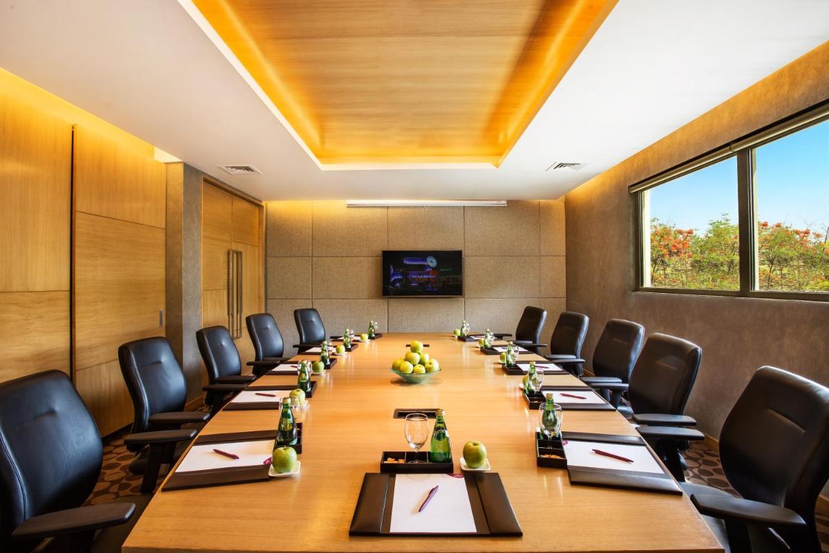 a conference room with a long table and chairs at Crowne Plaza Ahmedabad City Centre by IHG in Ahmedabad