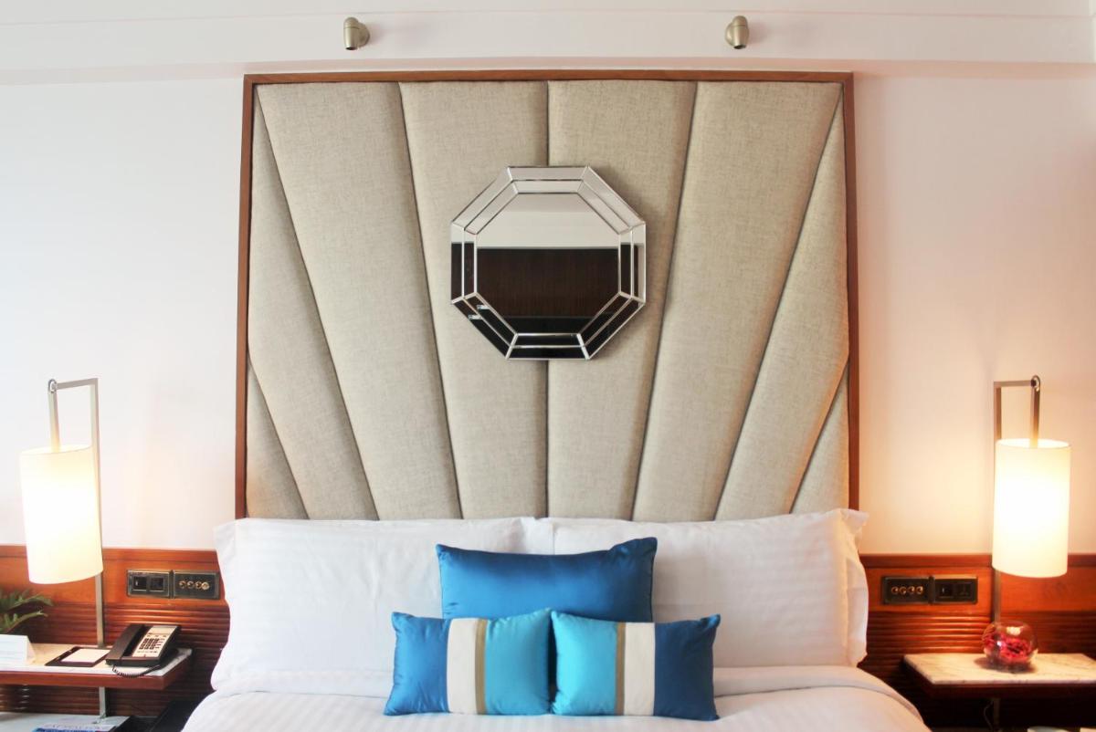 a bedroom with a large bed with a large headboard at InterContinental Marine Drive Mumbai by IHG in Mumbai