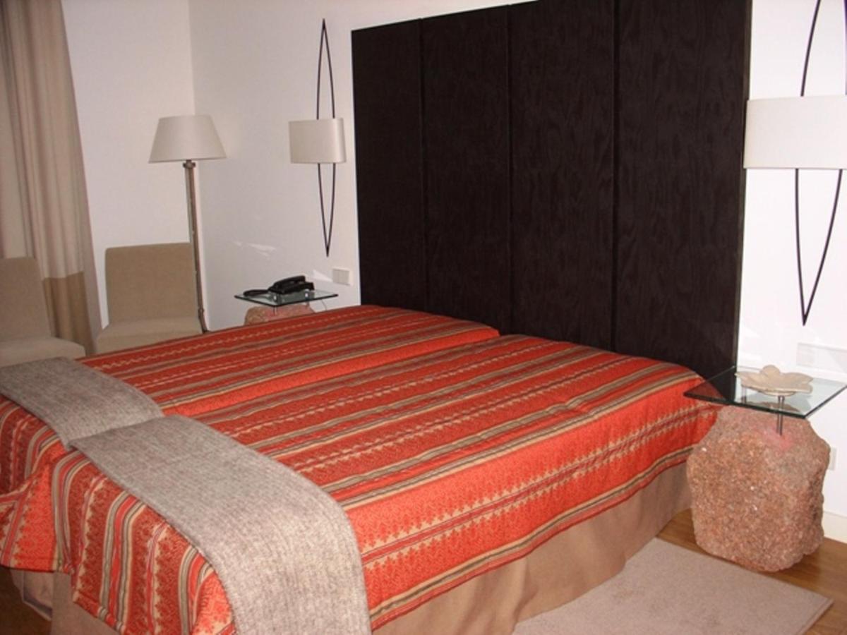 Uma cama ou camas num quarto em Hotel Convento dos Capuchos
