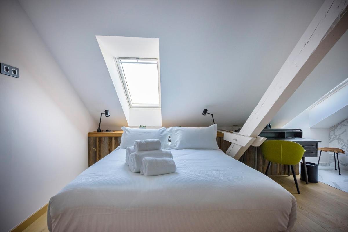 Un ou plusieurs lits dans un hébergement de l'établissement Hôtel La Garenne
