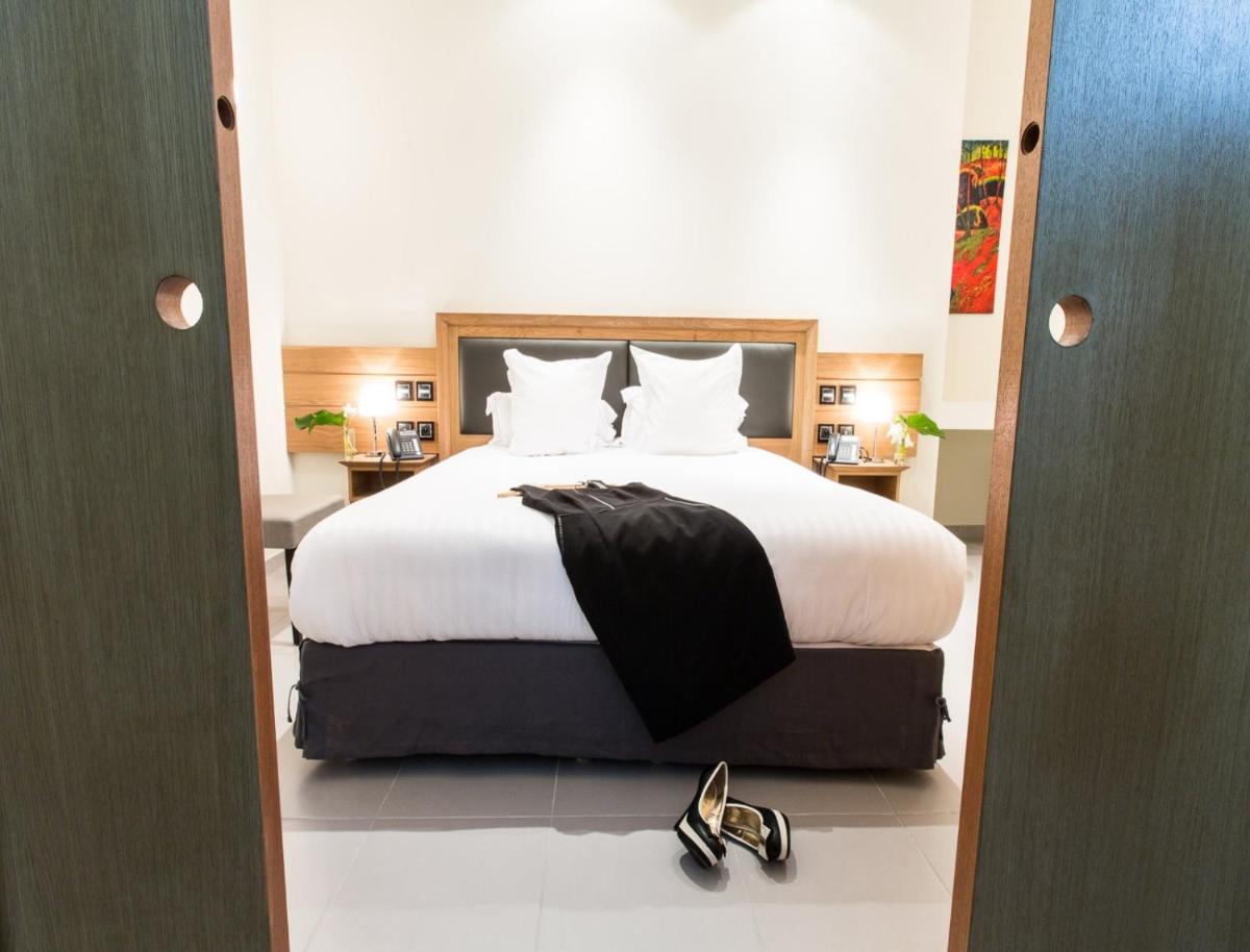 Un ou plusieurs lits dans un hébergement de l'établissement Hôtel Spa Marotte
