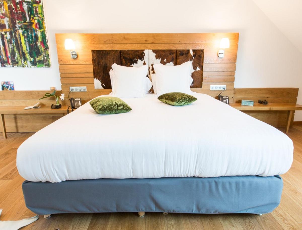 Un ou plusieurs lits dans un hébergement de l'établissement Hôtel Spa Marotte