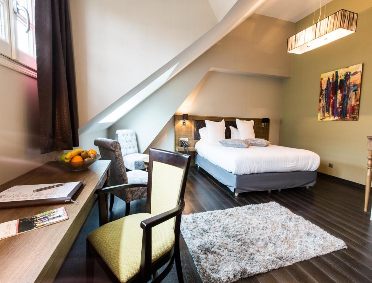 Un ou plusieurs lits dans un hébergement de l'établissement Hôtel Spa Marotte