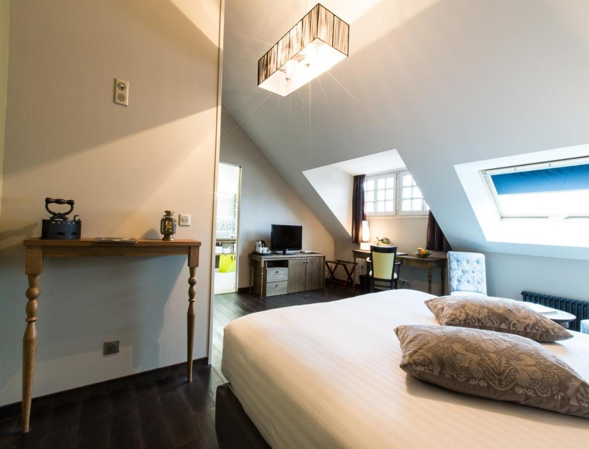 Un ou plusieurs lits dans un hébergement de l'établissement Hôtel Spa Marotte