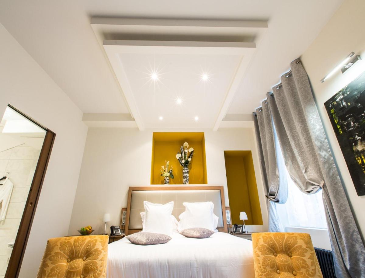 Un ou plusieurs lits dans un hébergement de l'établissement Hôtel Spa Marotte