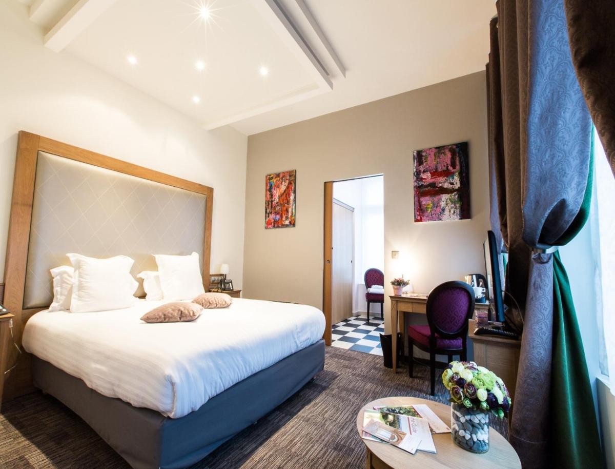 Un ou plusieurs lits dans un hébergement de l'établissement Hôtel Spa Marotte