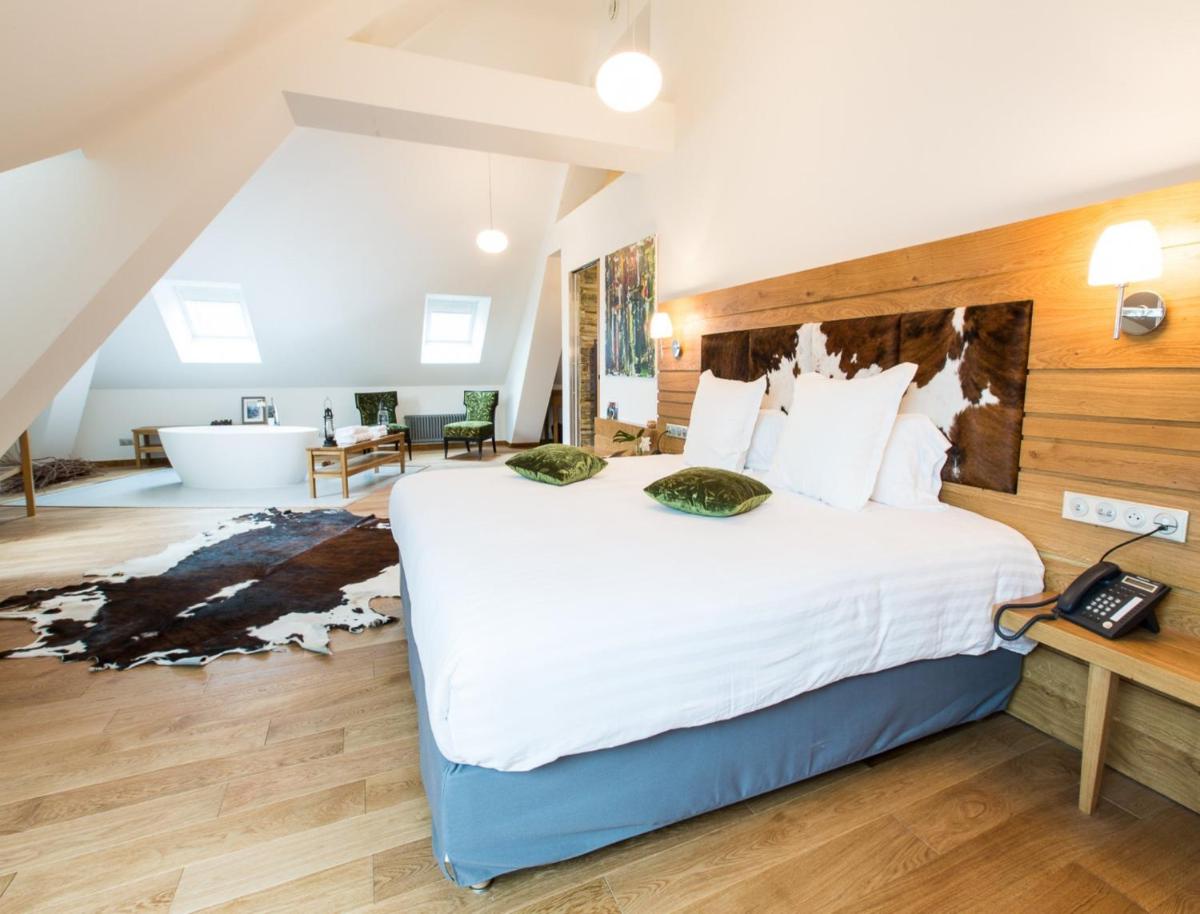 Un ou plusieurs lits dans un hébergement de l'établissement Hôtel Spa Marotte