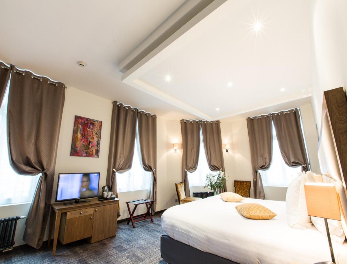 Un ou plusieurs lits dans un hébergement de l'établissement Hôtel Spa Marotte