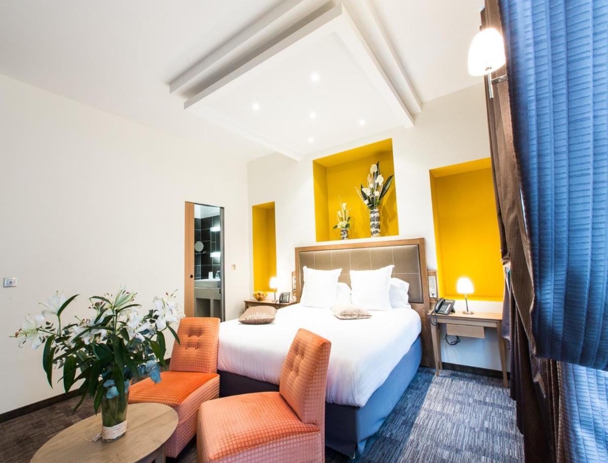 Un ou plusieurs lits dans un hébergement de l'établissement Hôtel Spa Marotte