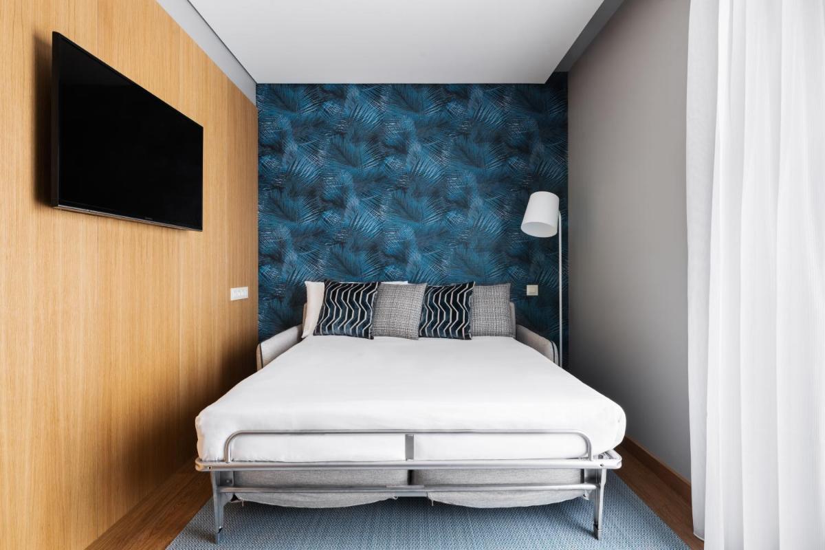 Uma cama ou camas num quarto em Eurostars Matosinhos